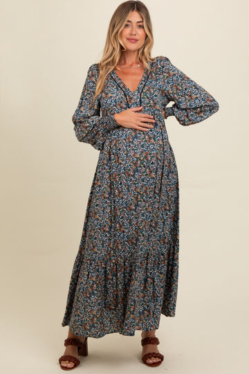 woman wearing a floral maternity maxi dress with long sleeves and a baby bump visible