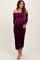 woman wearing a purple off-the-shoulder velvet maternity dress and showcasing her baby bump