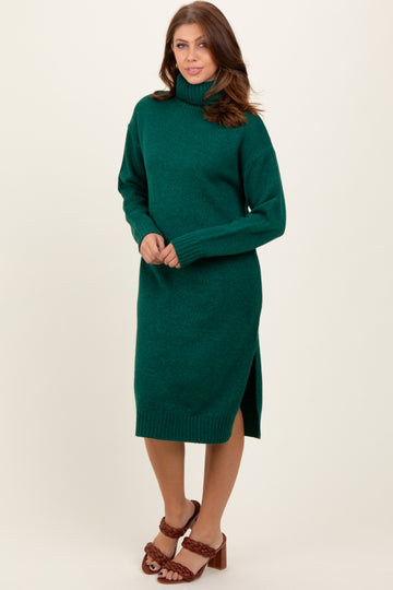 woman wearing a green turtleneck sweater dress with side slits and brown heeled sandals