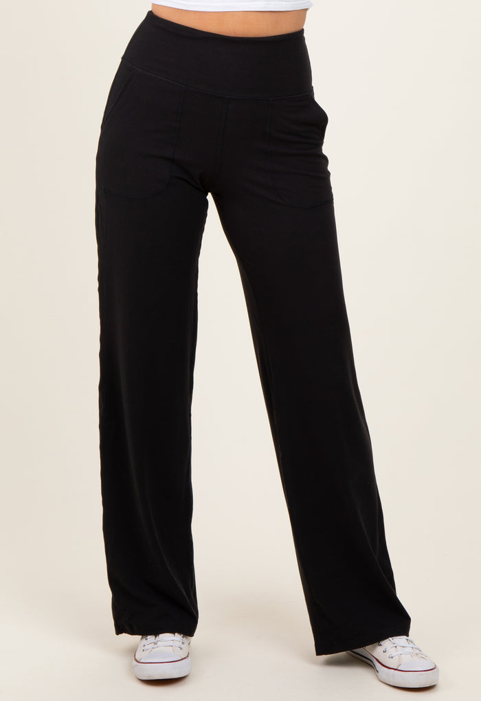 woman wearing black wide-leg pants with pockets and an elastic waistband