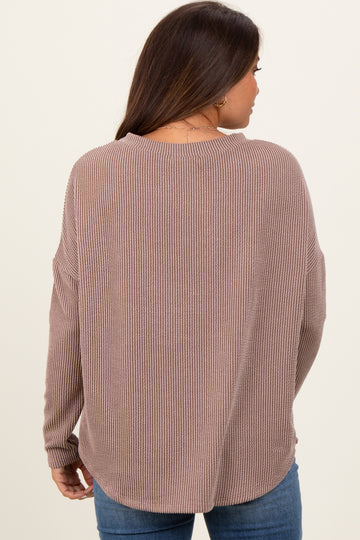 woman wearing a mauve ribbed maternity sweater with a relaxed fit
