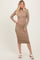 woman wearing a beige ribbed long sleeve midi dress and white block-heeled sandals