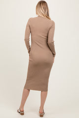 woman wearing a form-fitting beige ribbed dress with long sleeves, view from the back