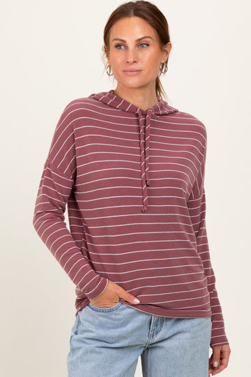 woman wearing a maroon and light gray striped hooded long sleeve sweatshirt with a relaxed fit and pockets