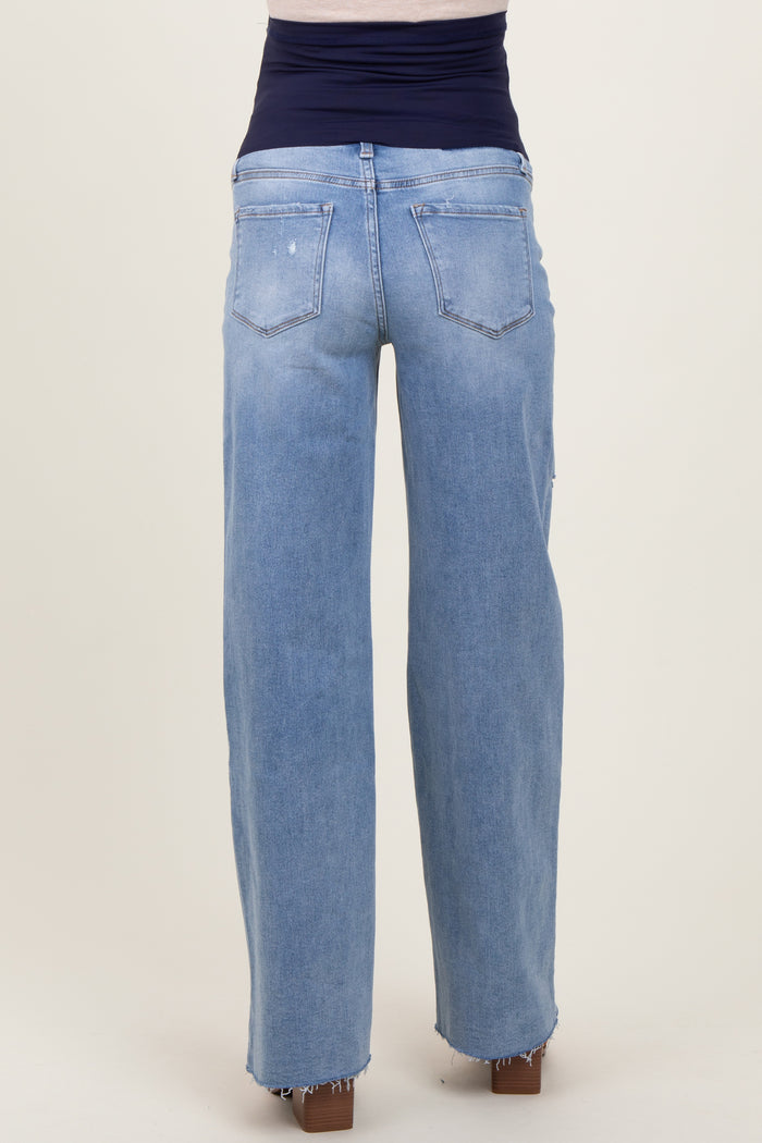 woman wearing light blue maternity jeans with a wide-leg fit and frayed hem, showing the back view