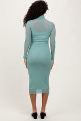 woman wearing a mint green long sleeve mesh bodycon dress, showing the back view