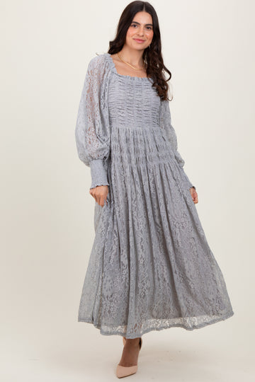 woman wearing a light grey long sleeve midi dress with lace overlay and puff sleeves