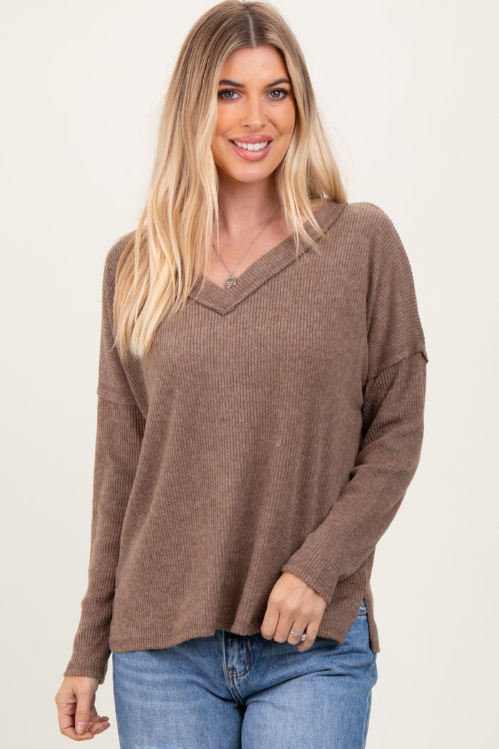 woman wearing a brown ribbed long sleeve v-neck top with relaxed fit and soft fabric