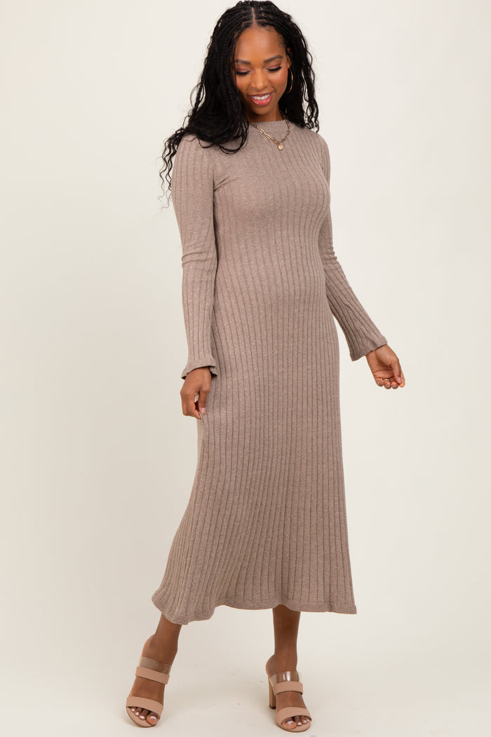 woman wearing a taupe ribbed midi dress with long sleeves and a fitted silhouette, paired with beige block-heeled sandals