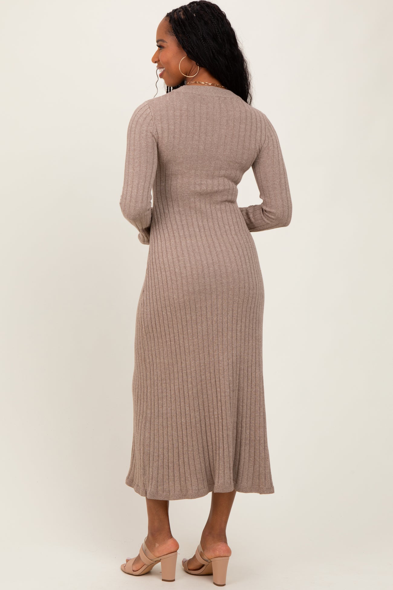 woman wearing a beige ribbed midi dress with long sleeves, shown from the back