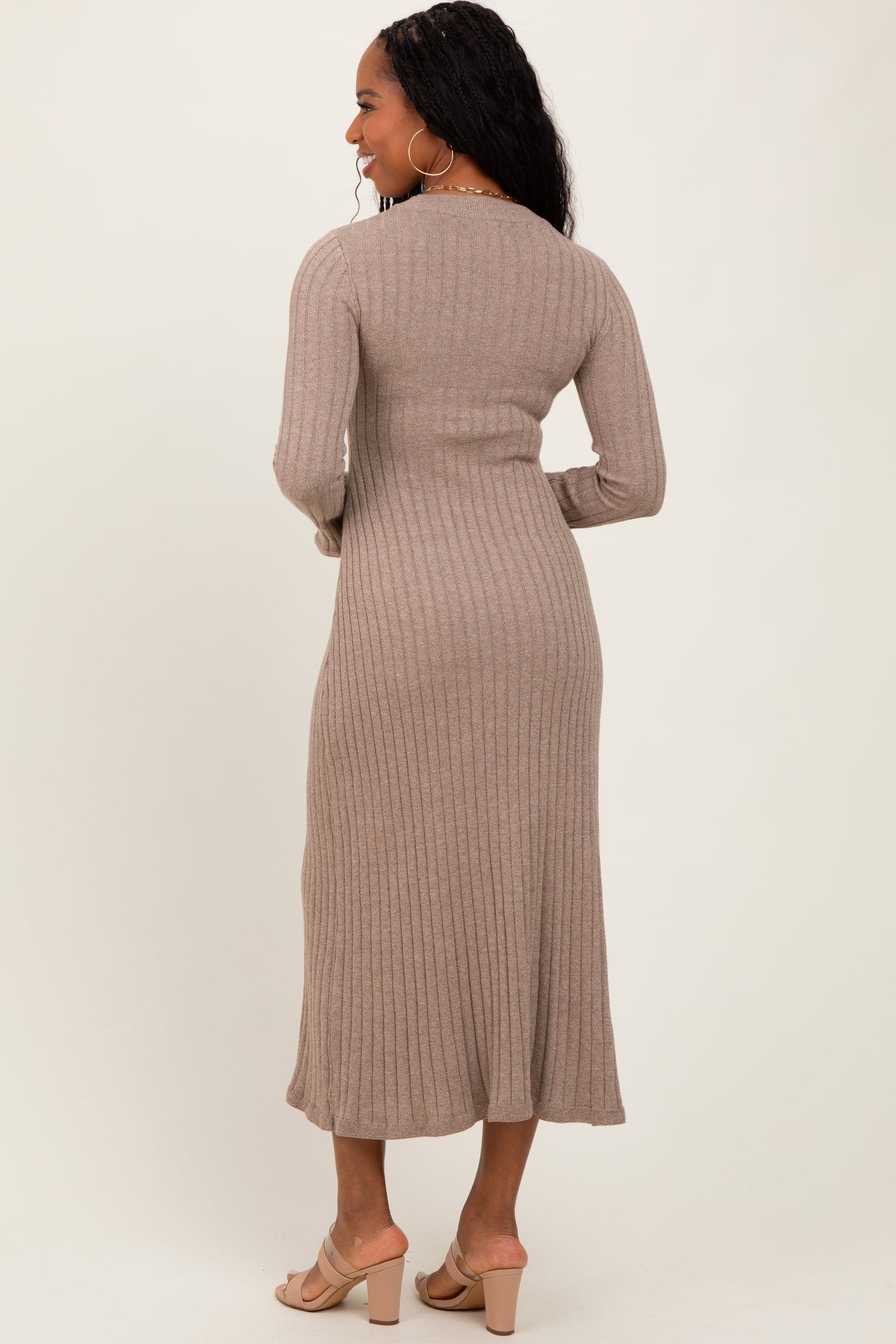 woman wearing a beige ribbed midi dress with long sleeves, shown from the back