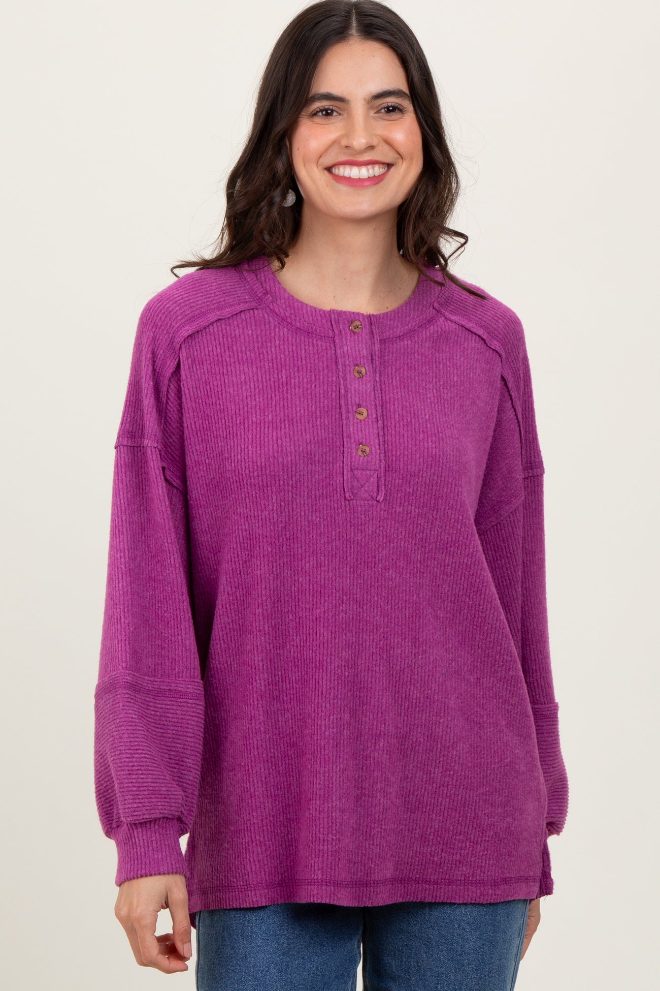 woman wearing a purple long sleeve button-up oversized sweater with ribbed texture and relaxed fit