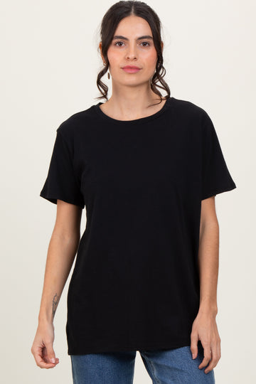 woman wearing a black short sleeve t-shirt with a relaxed fit and round neckline