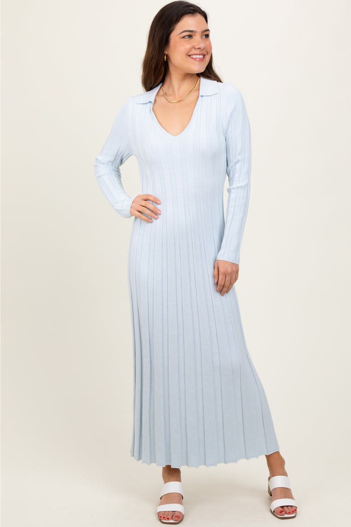 woman wearing a light blue ribbed long sleeve dress with a collared neckline and flared hem