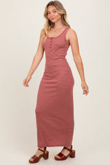 woman wearing a red and white striped maxi dress with button details and a fitted silhouette
