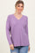 woman wearing a light purple long sleeve v-neck top with a relaxed fit and slouchy shoulders