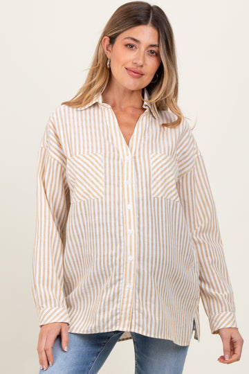 woman wearing a beige and white striped maternity shirt with long sleeves and a relaxed fit