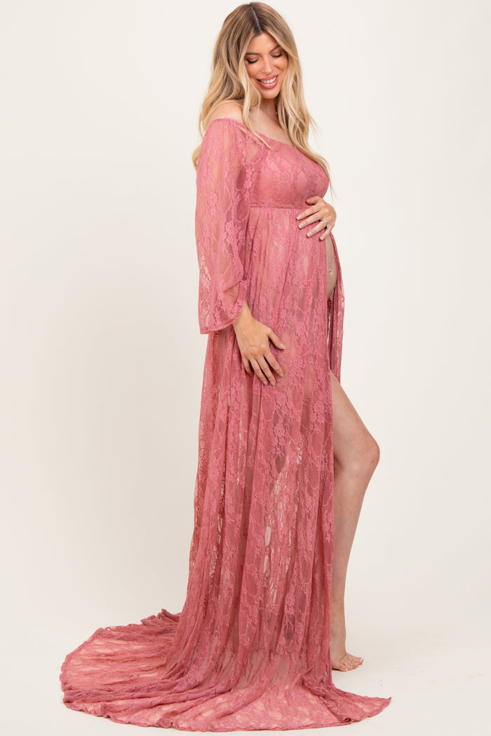 woman wearing a dusty rose lace maternity gown with off-the-shoulder sleeves and a flowing train, showing her baby bump