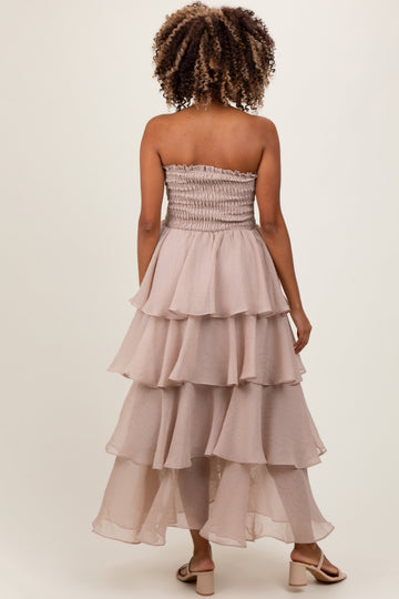 woman wearing a blush strapless maternity dress with tiered ruffle layers and smocked top, shown from the back