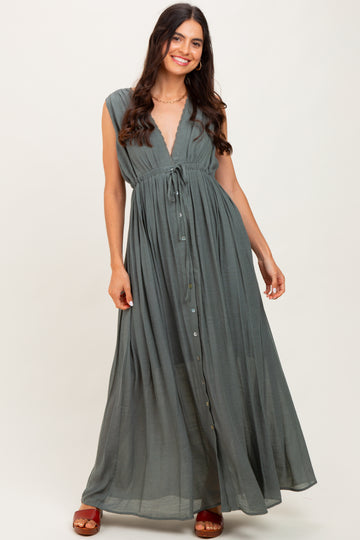 woman wearing a long olive green maxi dress with a deep v-neck and tie waist detail