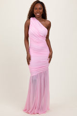woman wearing a pink one-shoulder evening gown with ruching and a sheer hemline