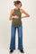 woman wearing an olive green ribbed maternity tank top and blue flared jeans, highlighting her baby bump