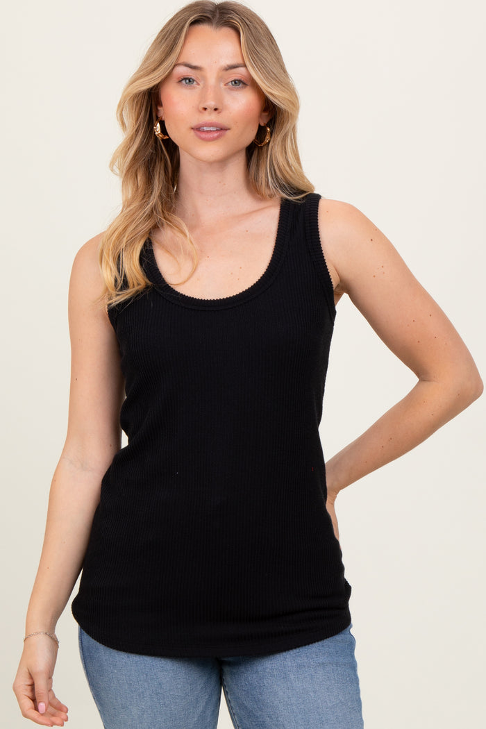 woman wearing a black ribbed tank top paired with light blue jeans