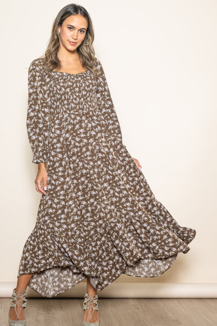 woman wearing a brown floral maxi dress with long sleeves and a smocked bodice