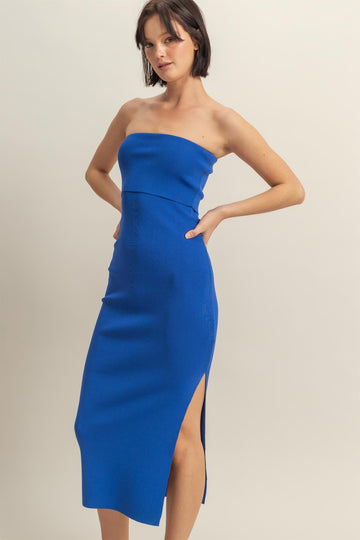 woman wearing a bright blue strapless midi dress with a side slit