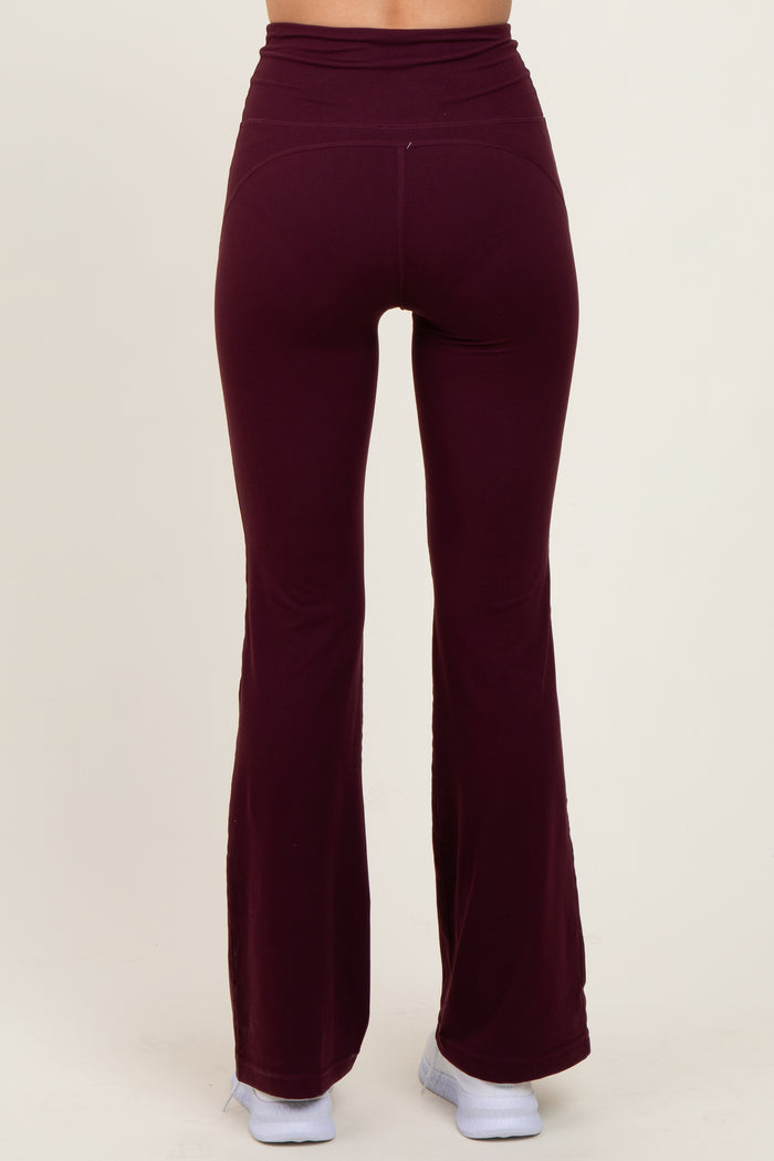 woman wearing burgundy flared leggings with a high waistband, viewed from the back