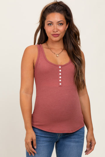 woman wearing a dusty rose maternity tank top with buttons, showing her baby bump, paired with blue jeans
