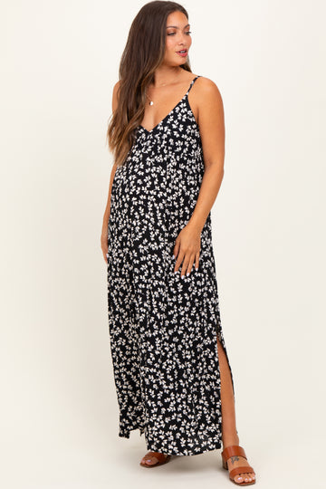 woman wearing a black floral maternity maxi dress with side slits and adjustable straps, showing her baby bump