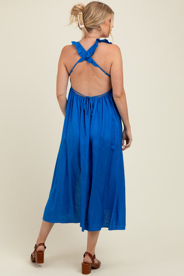 woman wearing a backless royal blue maternity maxi dress with ruffled straps and gathered waist