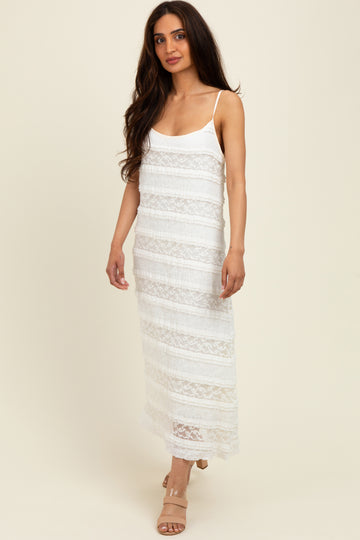 woman wearing a white lace maxi dress with adjustable spaghetti straps and a fitted silhouette