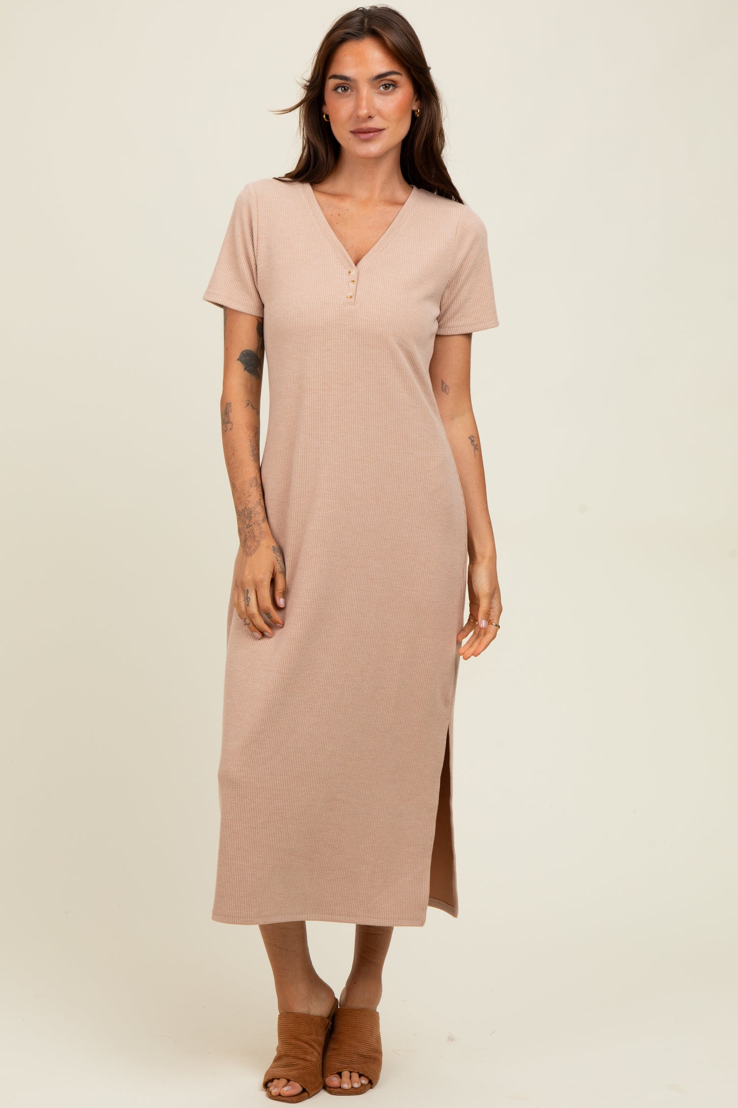 woman wearing a short sleeve beige ribbed maxi dress with a v-neck and side slit