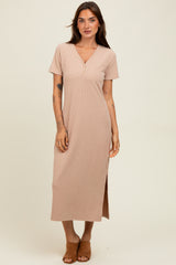woman wearing a short sleeve beige ribbed maxi dress with a v-neck and side slit