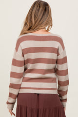woman wearing a beige and rust striped maternity sweater, viewed from the back