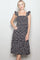 woman wearing a navy blue floral midi dress with ruffled straps and a tiered skirt