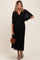 woman wearing a black pleated maternity dress with a deep v-neck and flowing sleeves, showing her baby bump