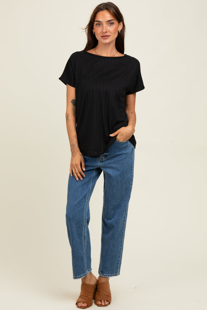 woman wearing a black ribbed short sleeve top with a relaxed fit and blue high-waisted straight leg jeans