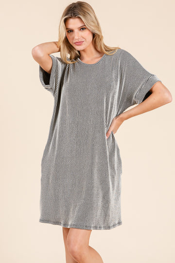 woman wearing a black and white striped oversized t-shirt dress with short sleeves and side pockets