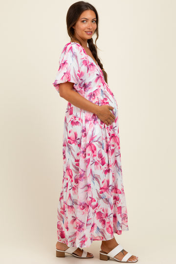 woman wearing a floral maternity maxi dress with short sleeves and a baby bump visible