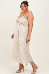 woman wearing a floral print plus size maxi dress with adjustable straps and a bow detail, paired with nude heels