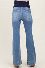 woman wearing light blue maternity flared jeans with a stretchy dark waistband, showcasing the back view