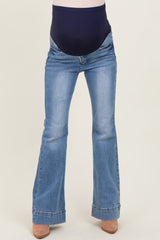 maternity wear light wash flared jeans with a navy blue over-the-belly panel, model not shown wearing them