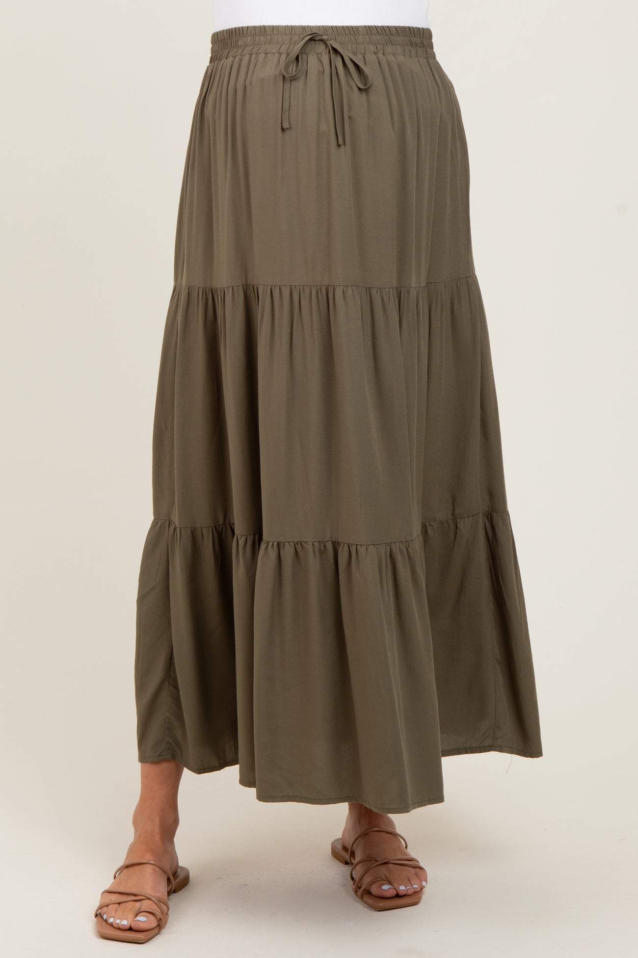 maternity wear olive green tiered maxi skirt with elastic waistband and drawstring, model wearing it without a visible baby bump