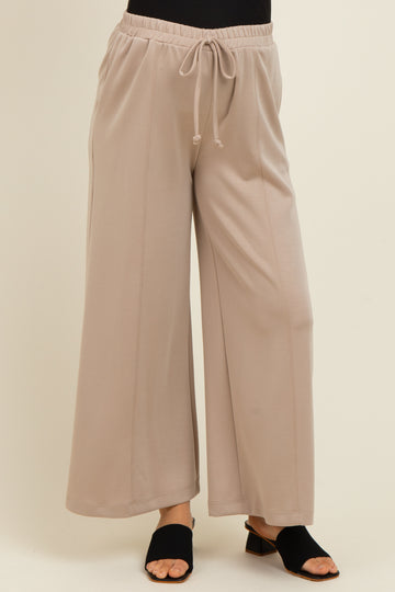 woman wearing light gray wide-leg maternity pants with an elastic waistband and drawstring detail