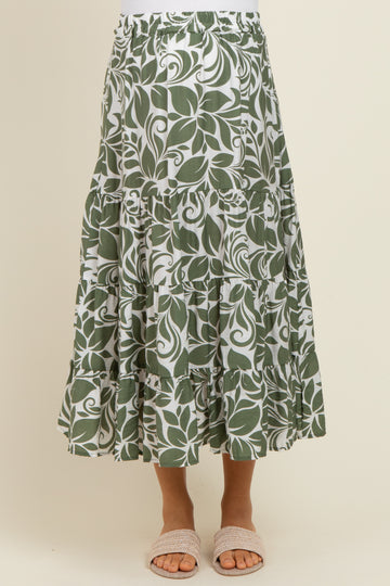 maternity wear green leaf patterned maxi skirt with tiered ruffles and an elastic waistband, model wearing sandals