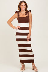 woman wearing a brown and white striped knit maxi dress with square neckline and bow shoulder straps