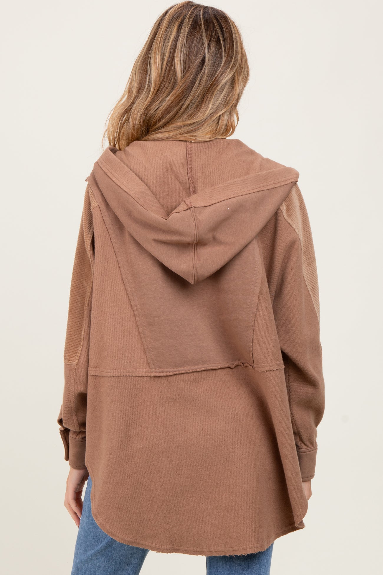 woman wearing a brown maternity hoodie with a relaxed fit and a hood, seen from the back